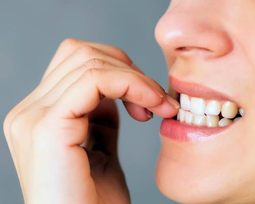 Closeup of woman biting her nails