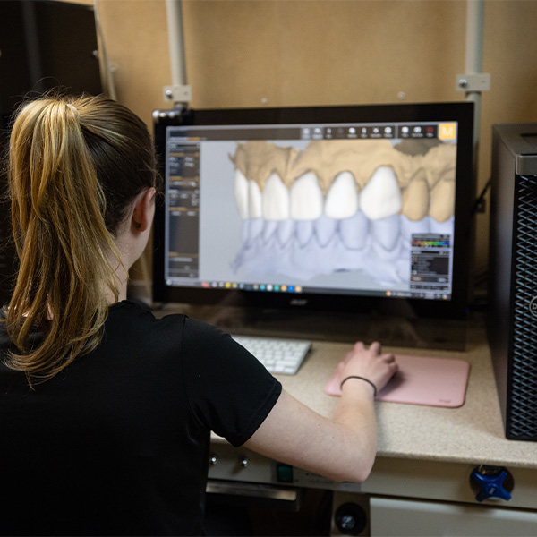 Dentist showing patient scan of their teeth