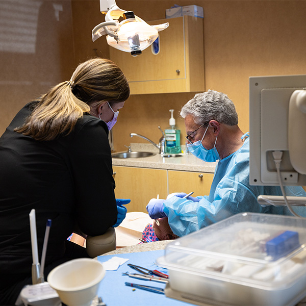 Female dental patient laughing and talking to dentist